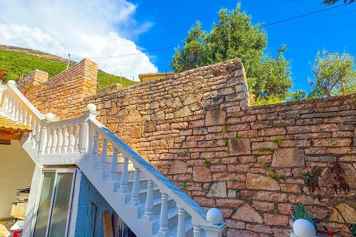 Stone stairway leading up through the property